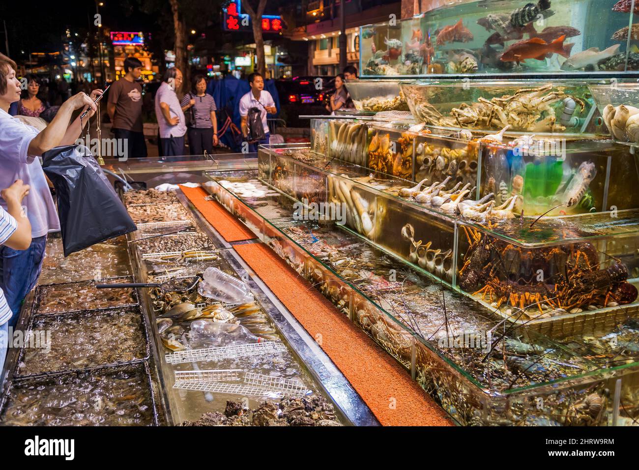 Live fish and seafood, including endangered horseshoe crabs, on display in tanks outside a restaurant at Sai Kung waterfront, Hong Kong Stock Photo