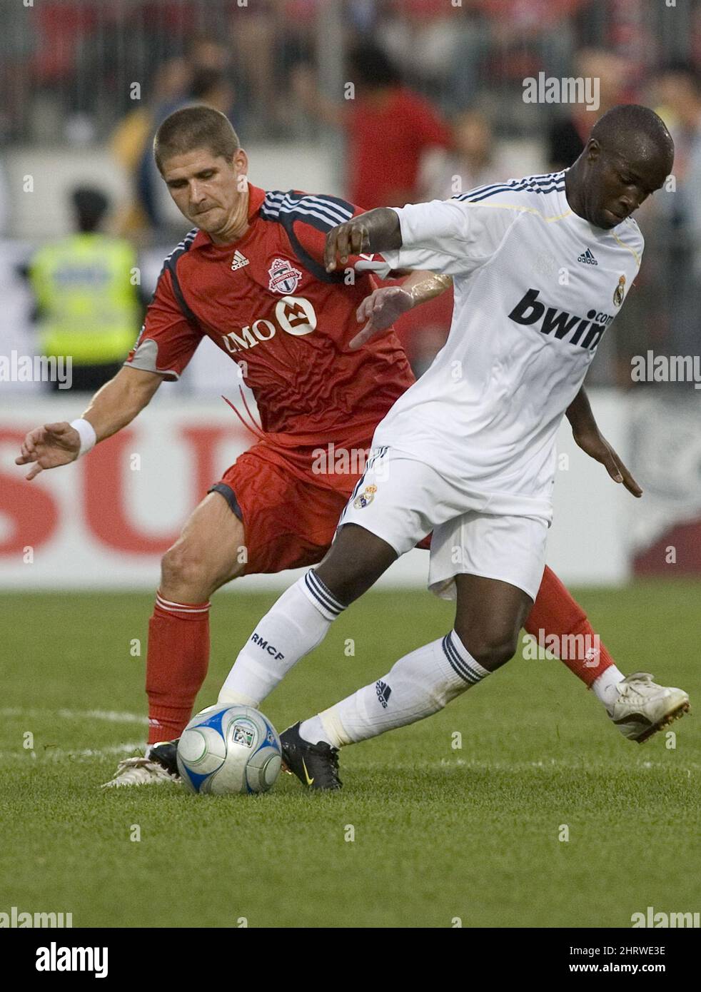Real Madrid's Lassana Diarra takes the ball away from Toronto FC's Carl Robinson during the first half of a friendly soccer match in Toronto on Friday, Aug. 7, 2009. (AP Photo/The Canadian Press, Chris Young) Stock Photo