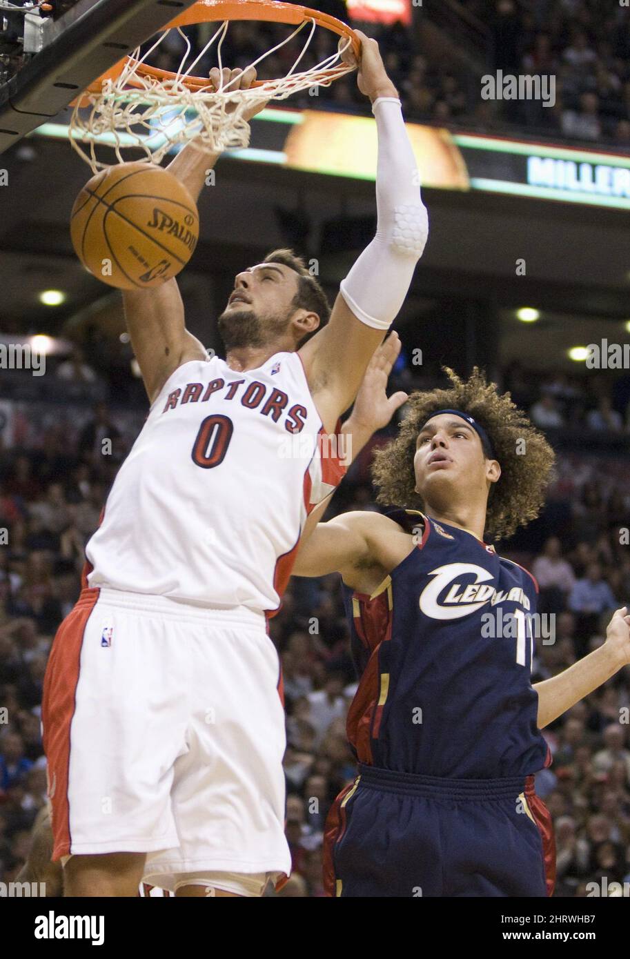 Toronto Raptors guard Marco Belinelli (0) slams home a dunk in front of  Cleveland Cavaliers forward Anderson Varejao (17) during first half NBA  action in Toronto on Wednesday, October 28, 2009. THE, image size:913x1390