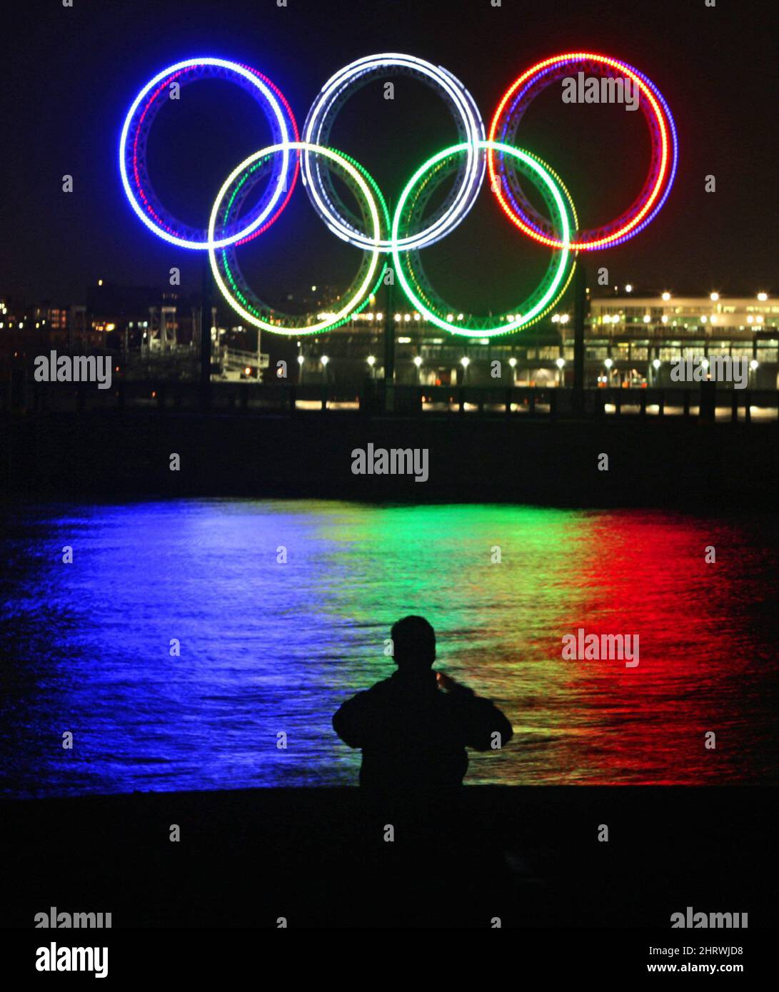 A photographer takes photographs of a 14 metre tall set of Olympic