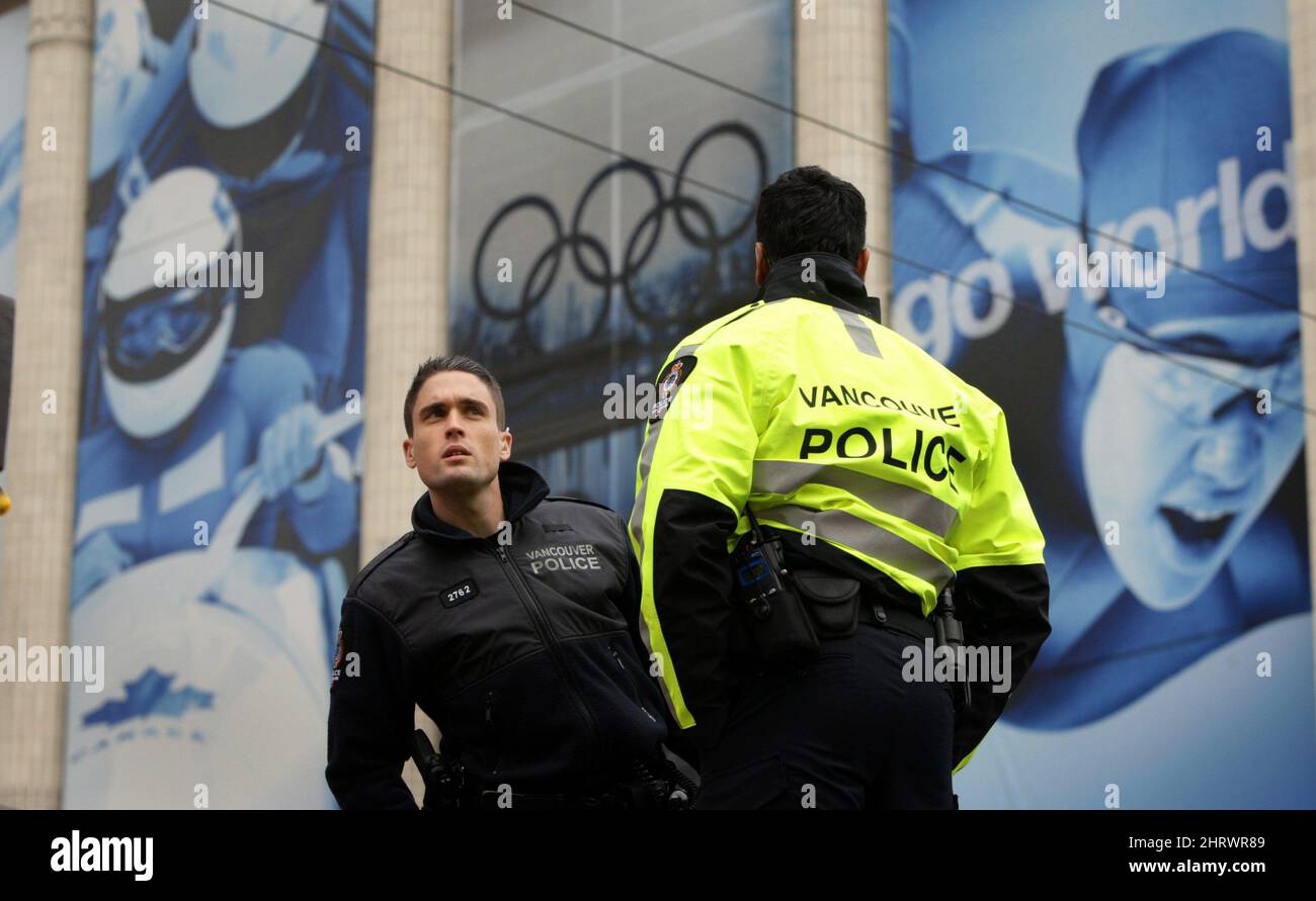 Olympic banners adorn the outside of The Bay building as police officers stand at the scene after an underground explosion sent three B.C. Hydro workers to hospital in Vancouver, B.C., on Wednesday December 23, 2009. The incident forced the closure of West Georgia St., a main thoroughfare through the downtown core, causing long lineups of traffic. Thursday will mark 50 days until the start of the Vancouver 2010 Winter Olympic Games. THE CANADIAN PRESS/Darryl Dyck Stock Photo