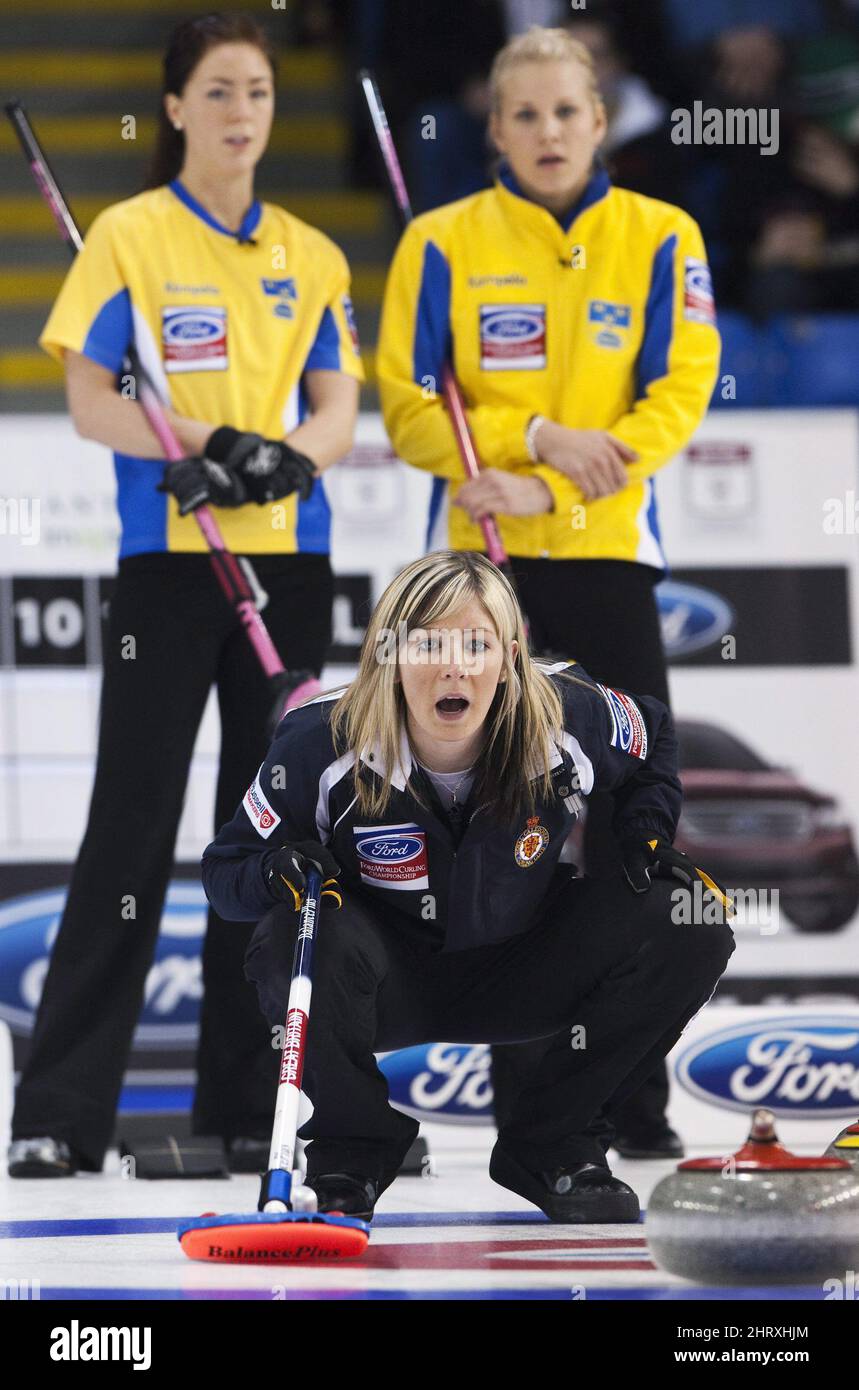Sweden skip Cecilia Ostlund, bottom, watches her teams rock curl as Canada skip Jennifer Jones, back looks on in the bronze medal game during the 2010 World Womens Curling Championships in Swift