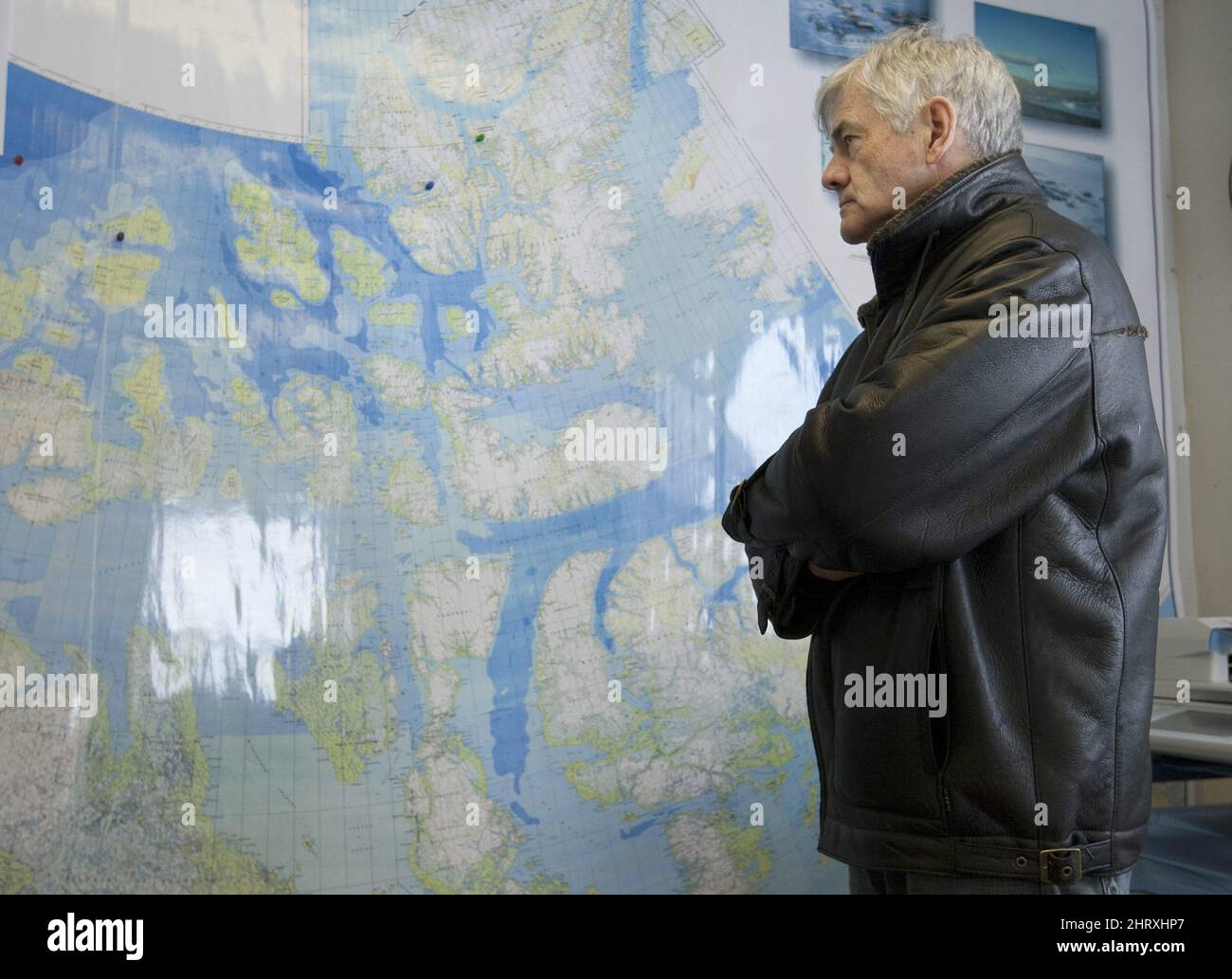 Minister of Foreign Affairs Lawrence Cannon surveys a map of northern