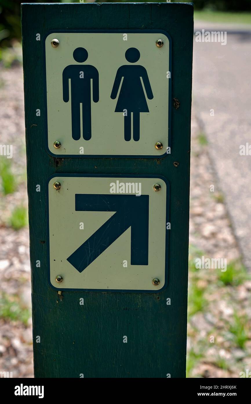 Information sign indicating male and female public toilets in a national park. Stock Photo