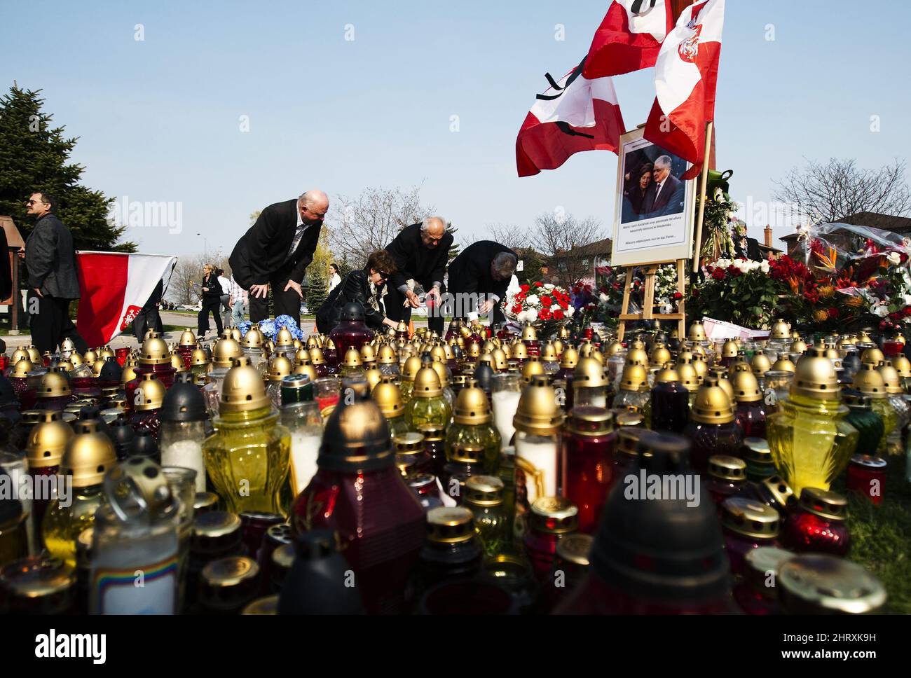 People light candles before a memorial mass in Mississauga, Ont., on