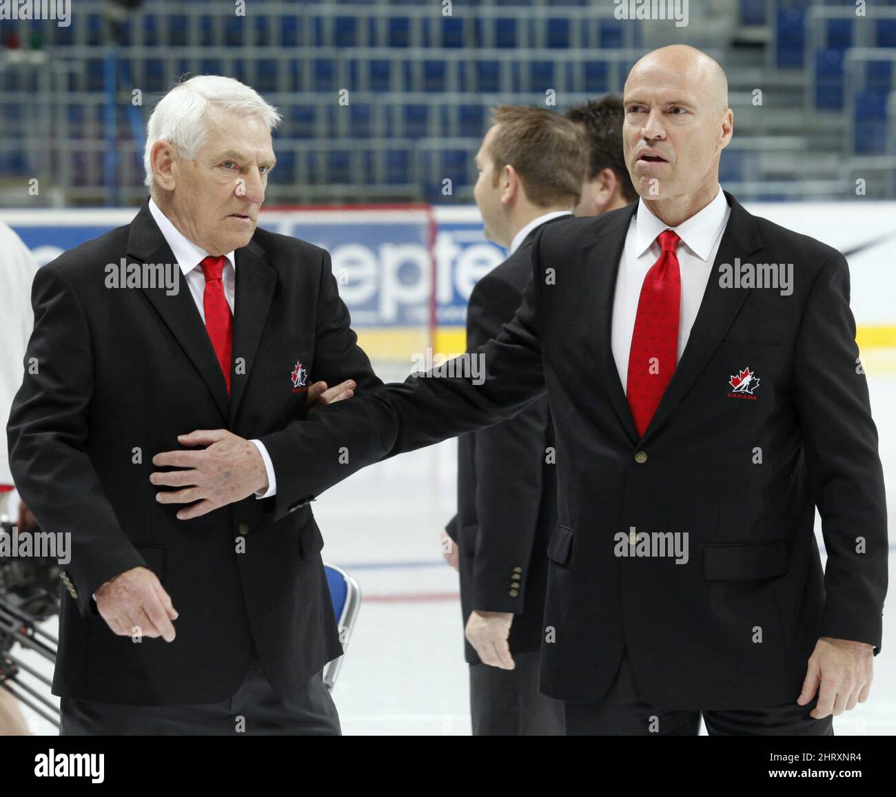 Team Canada general manager Mark Messier helps his father, Doug, manager of the team, onto the ice as they prepare for the team photo, Monday May 17, 2010, at the IIHF world hockey championship in Mannheim, Germany. (AP Photo/The Canadian Press, Jacques Boissinot) Stock Photo