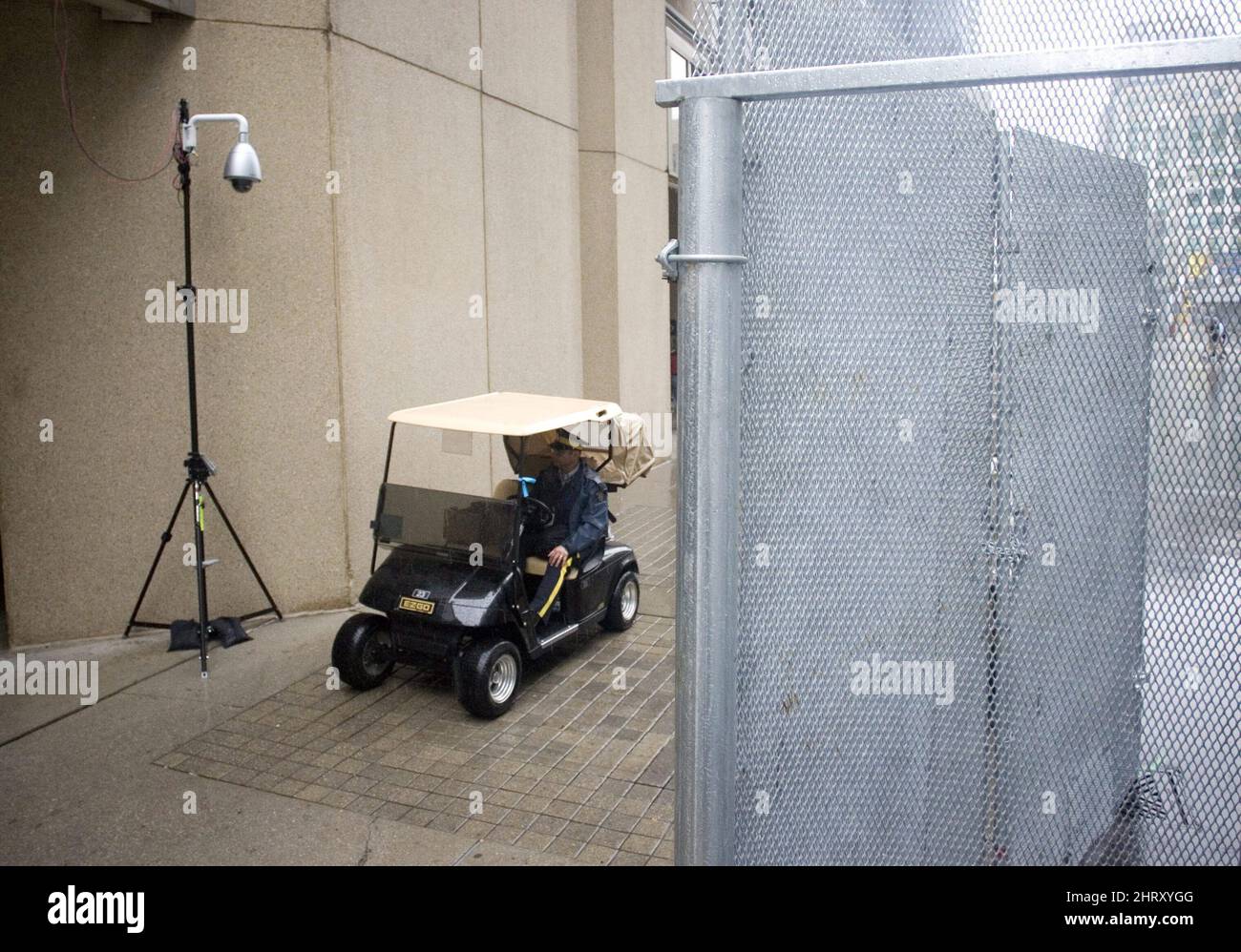Rcmp Security A RCMP officer passes underneath a camera inside the security fence ...