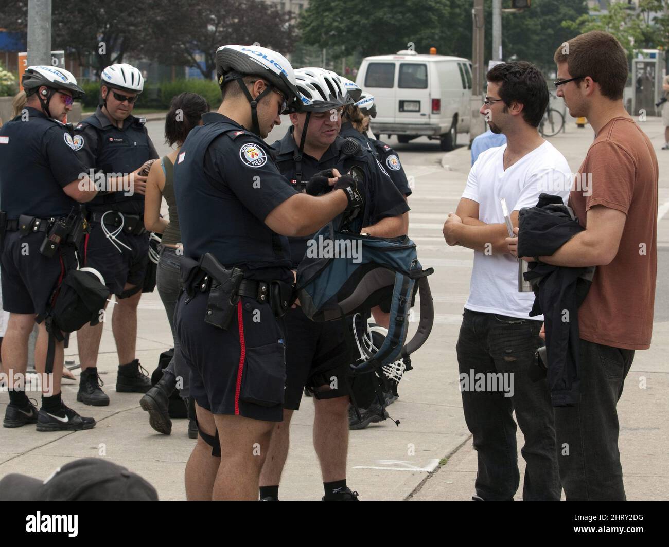 Police search the backpacks of pedestrians neer Queen's Park Sunday ...