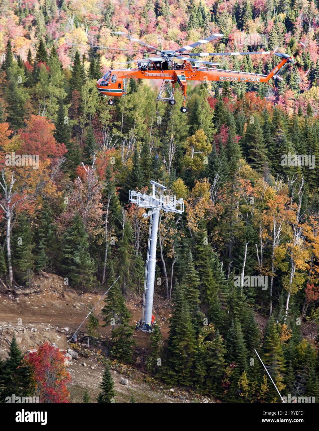 A helicrane carries a pylon to its base as ski resort Le Massif ...