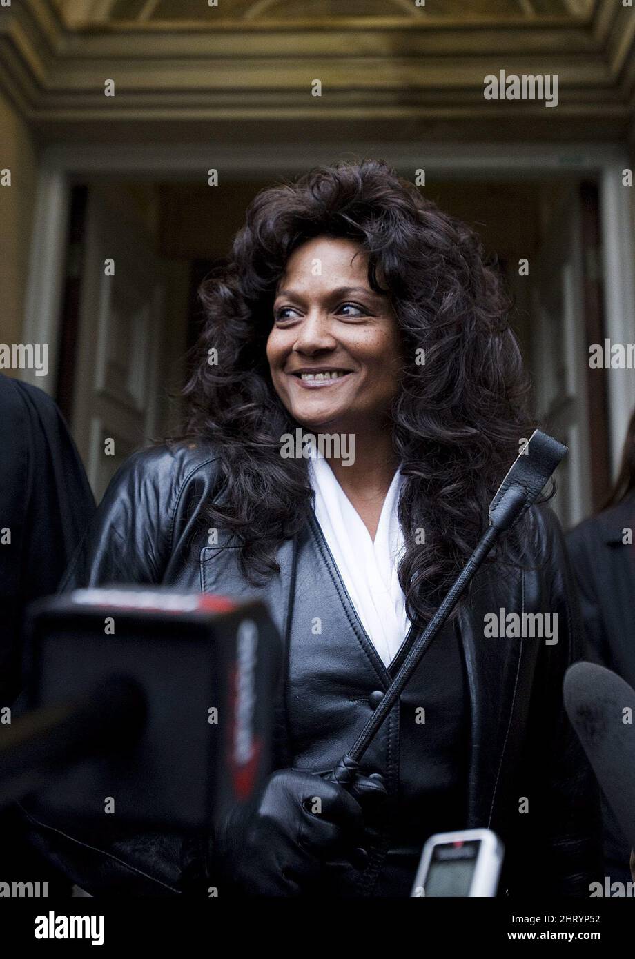Dominatrix Terri-Jean Bedford holds a riding crop and smiles outside an  Ontario Court of Appeal in Toronto, Monday, Nov.22, 2010. Bedford was  attending as the Ontario Court of Appeal hears the federal