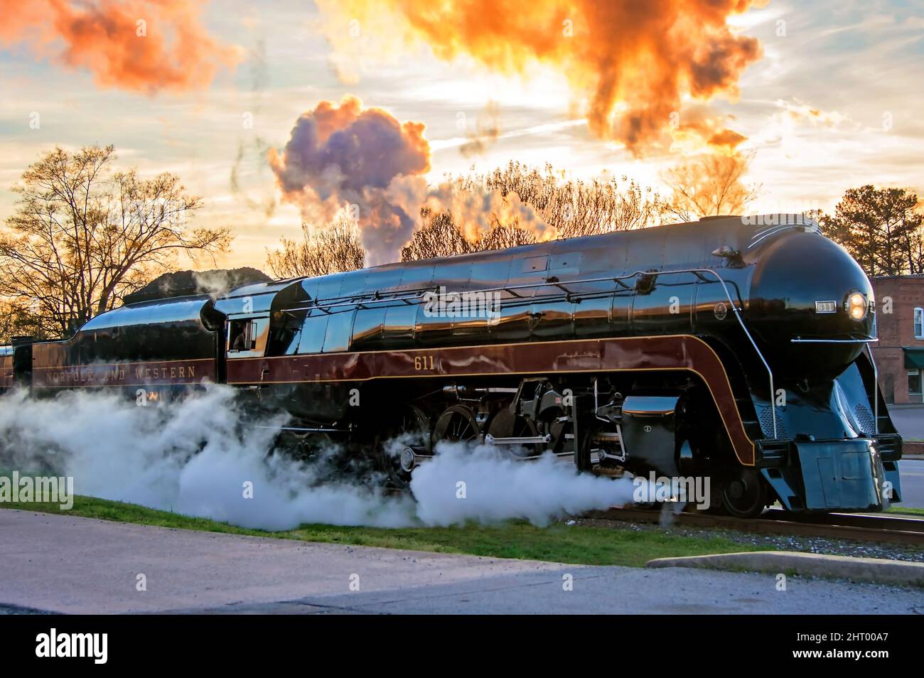 Black steam locomotive arriving at the station Stock Photo - Alamy