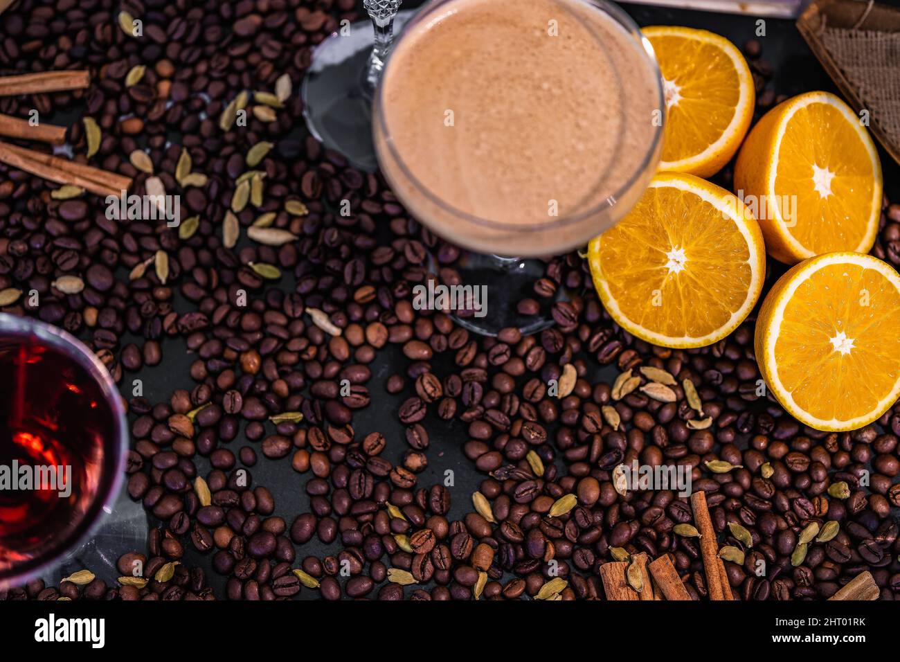 Top view of a bar table with an espresso martini, orange slices and