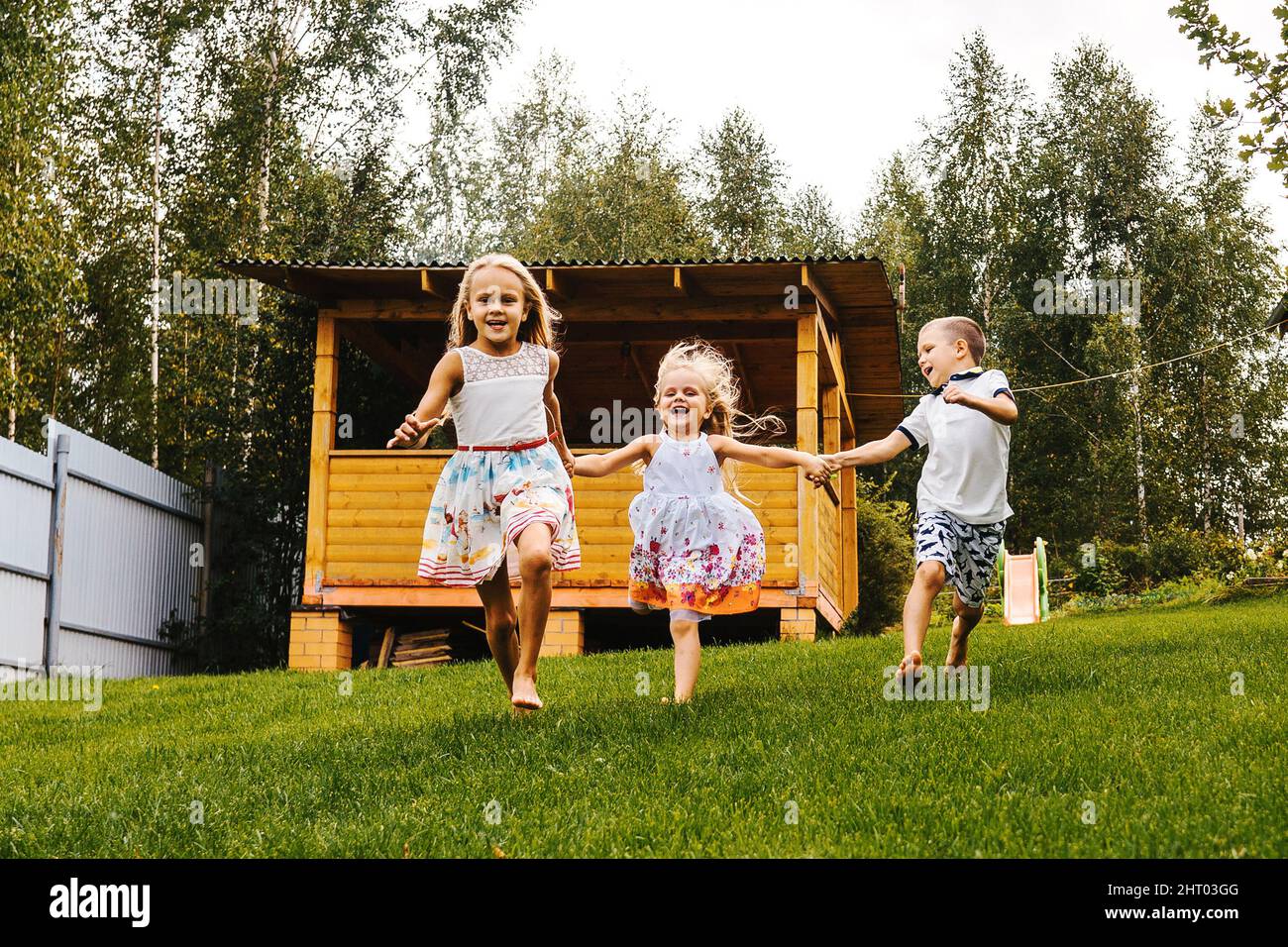 Kids running in garden hi-res stock photography and images - Alamy