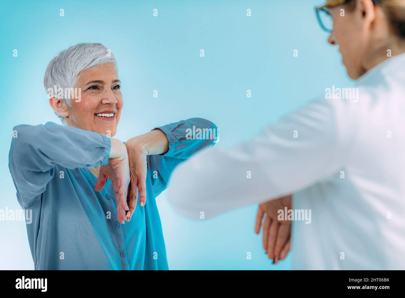 Doctor checking a senior woman for carpal tunnel syndrome Stock Photo