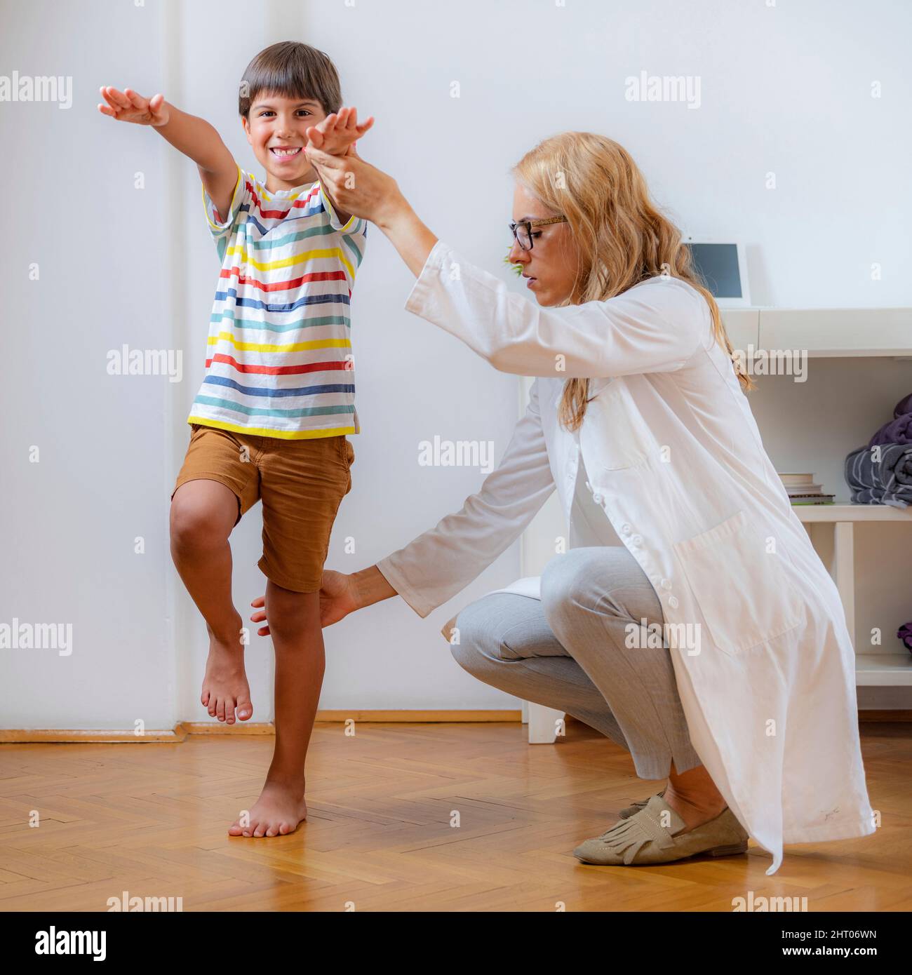 Physical therapist doing medical exam with a boy Stock Photo