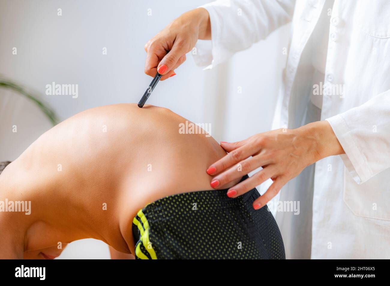 Pediatrician checking a boy's spine Stock Photo