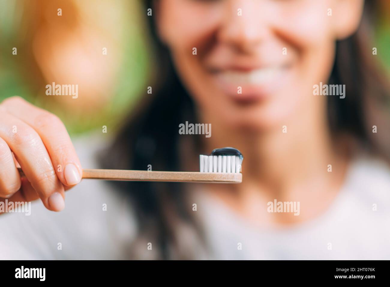 Toothpaste with black charcoal on wooden toothbrush Stock Photo