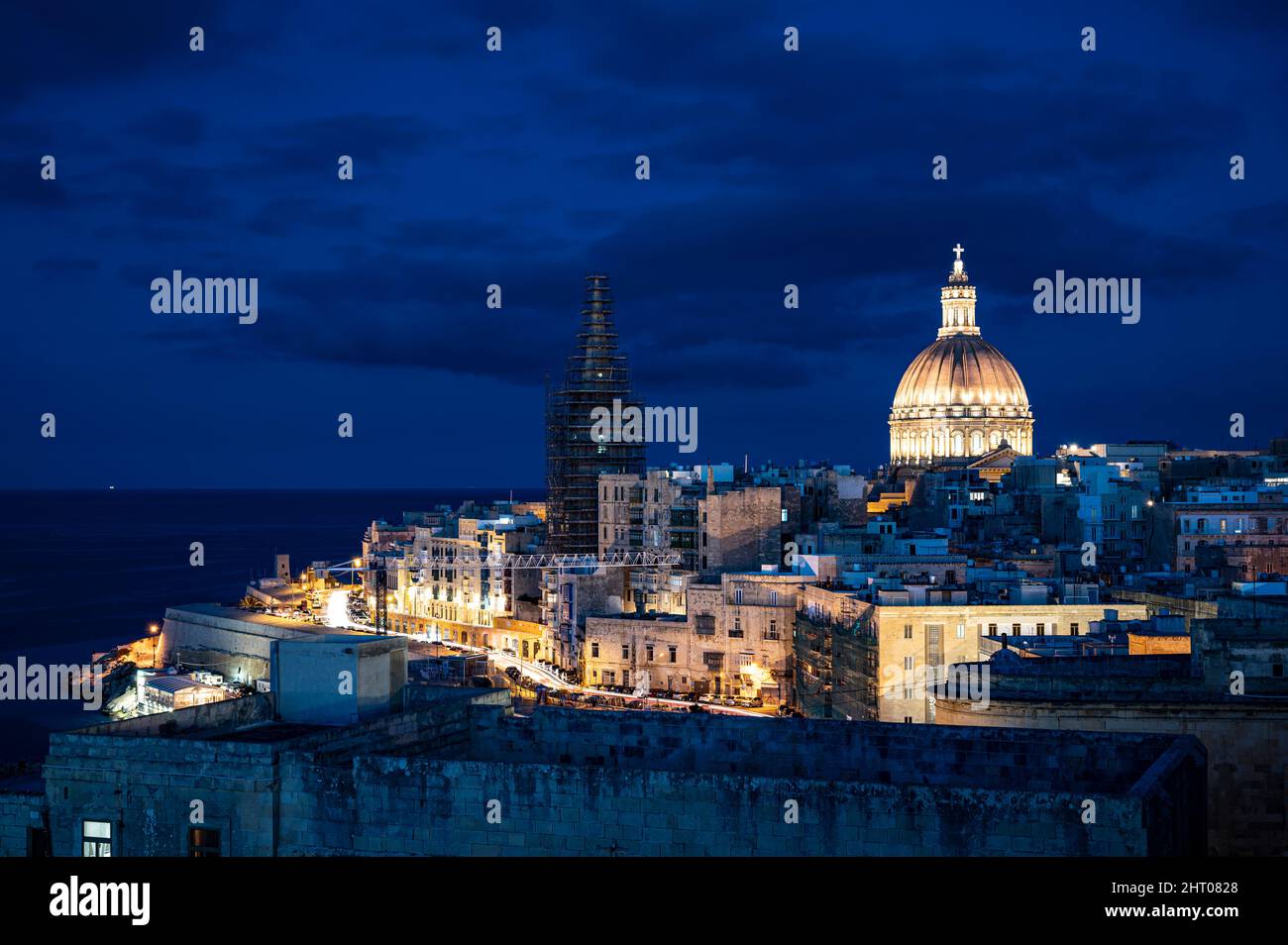 Panoramic view of illuminated at night Valletta old town and harbor in Valletta, Malta. Stock Photo