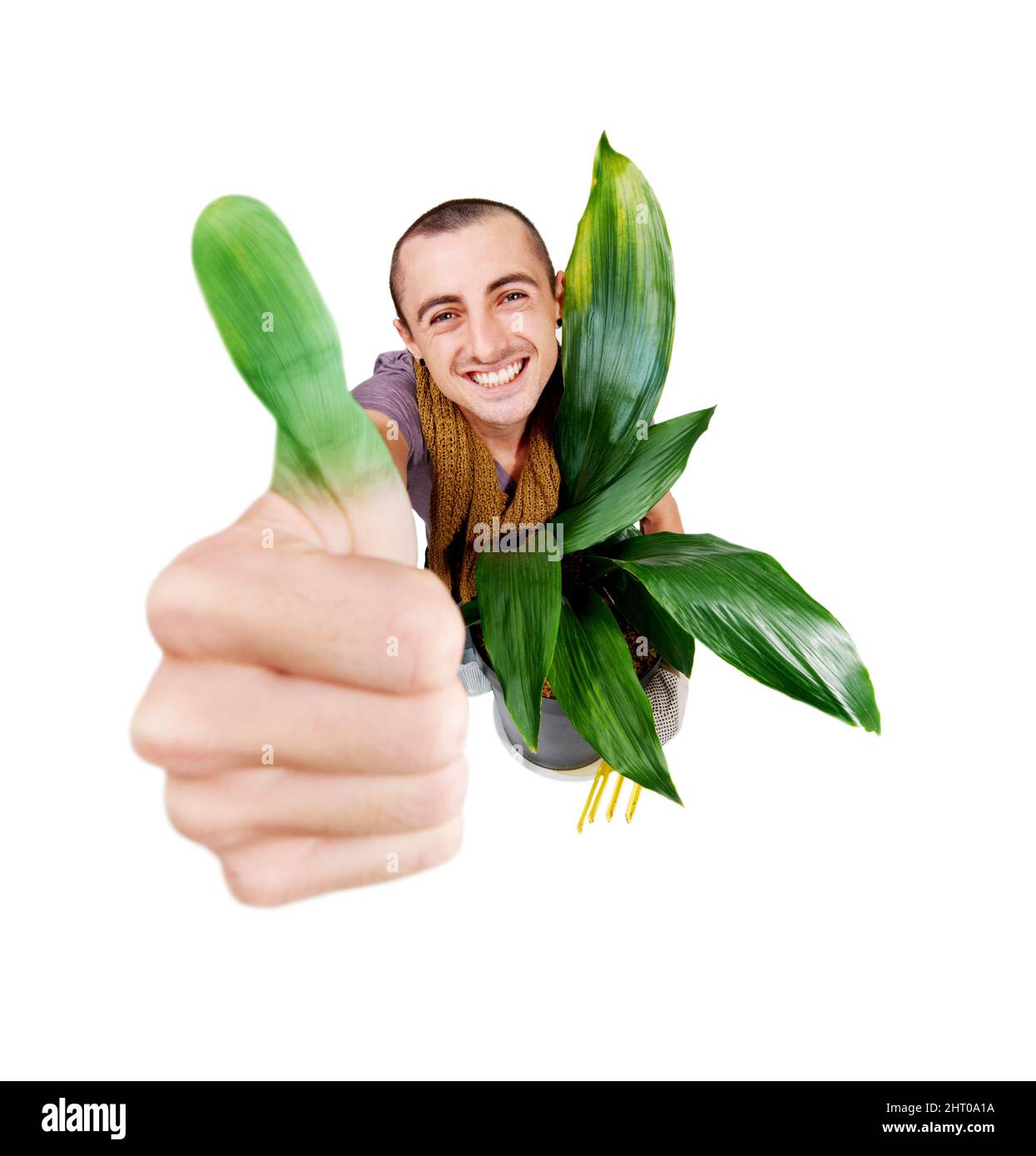 Green fingers. A smiling young gardener holding up his green thumb. Stock Photo