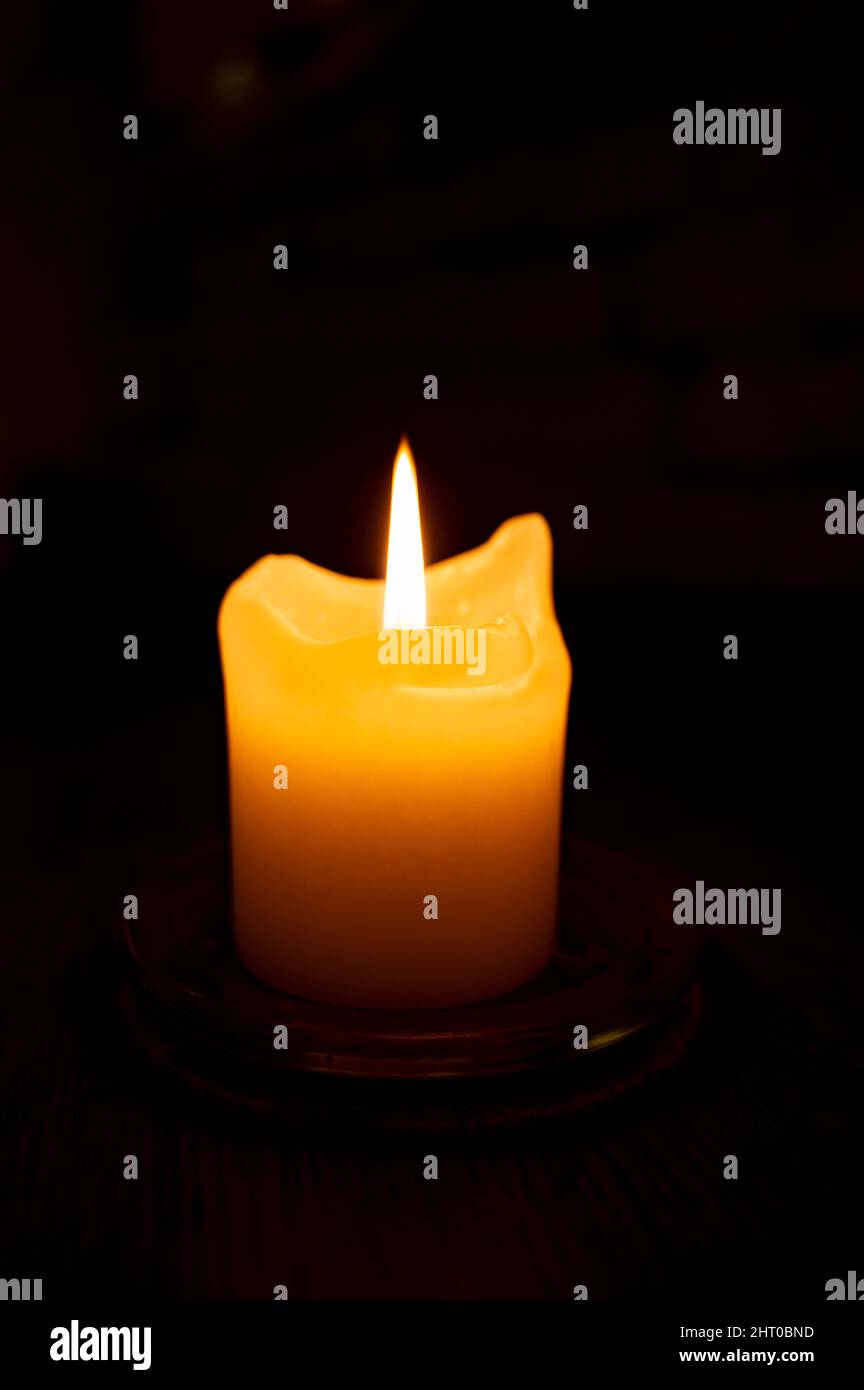 One burning candle in dark underground shelter close up Stock Photo Alamy