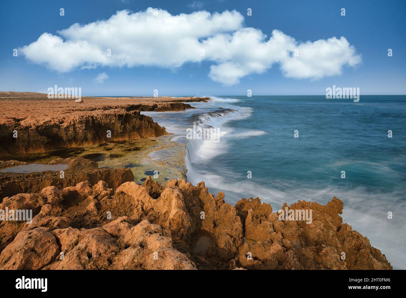 Long exposure capture of the rough waters on the rugged Indian Ocean coastline at Quobba Station in Western Australia. Stock Photo