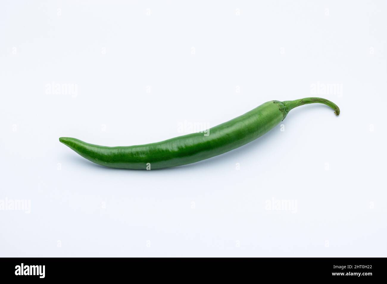 Green chili pepper isolated on a white background Stock Photo - Alamy
