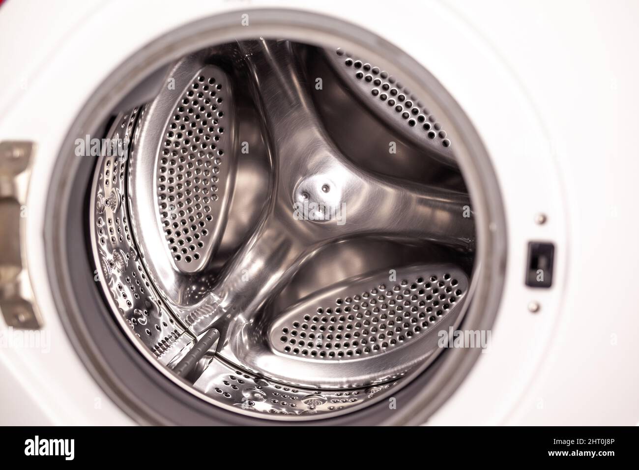 Drum of washing machine dry and clean close-up. Washing Dryer Machine inside view of a drum. Stock Photo