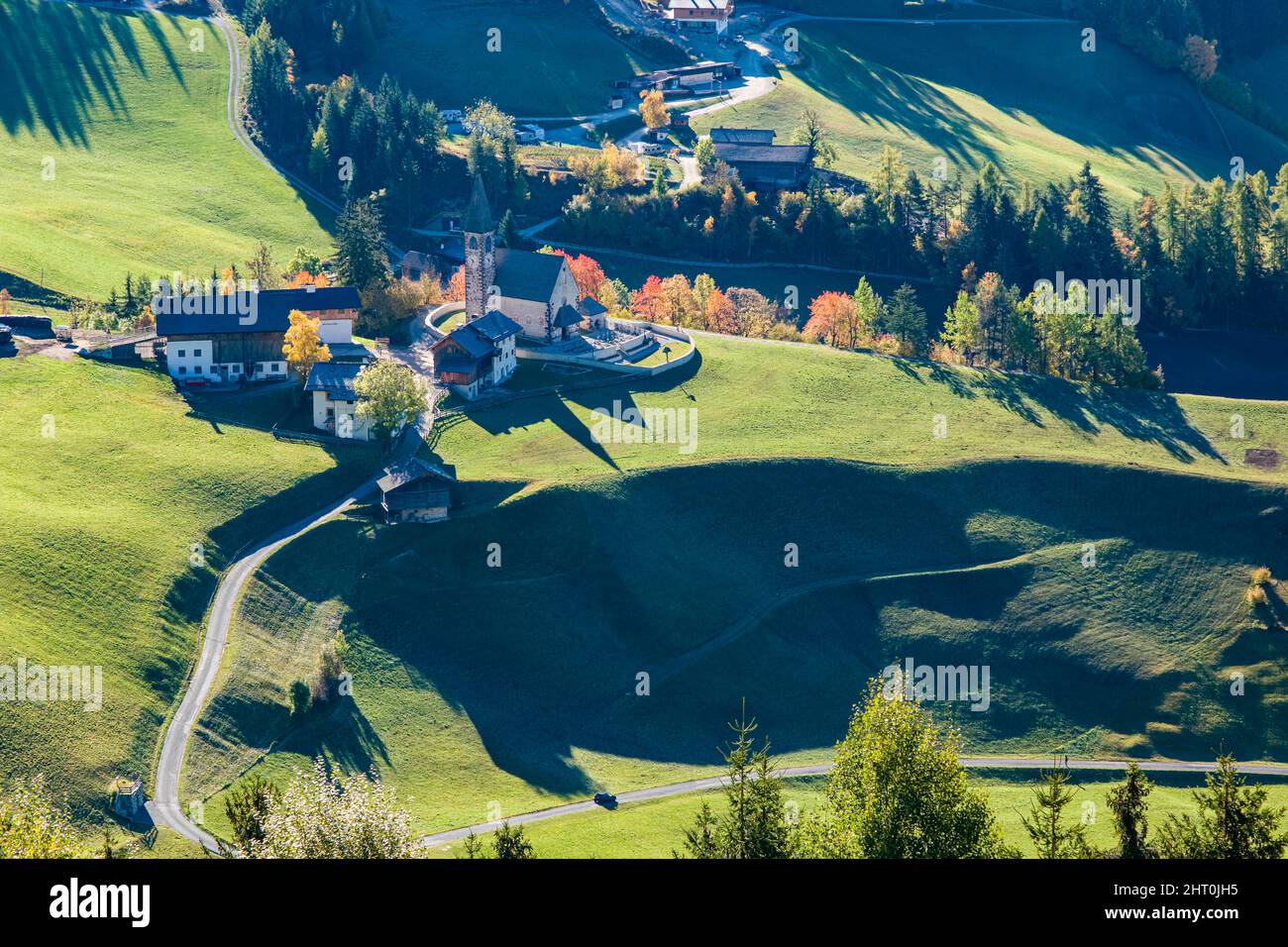 Aerial view of the Church of St. Magdalena in Villnöss valley in autumn. Stock Photo
