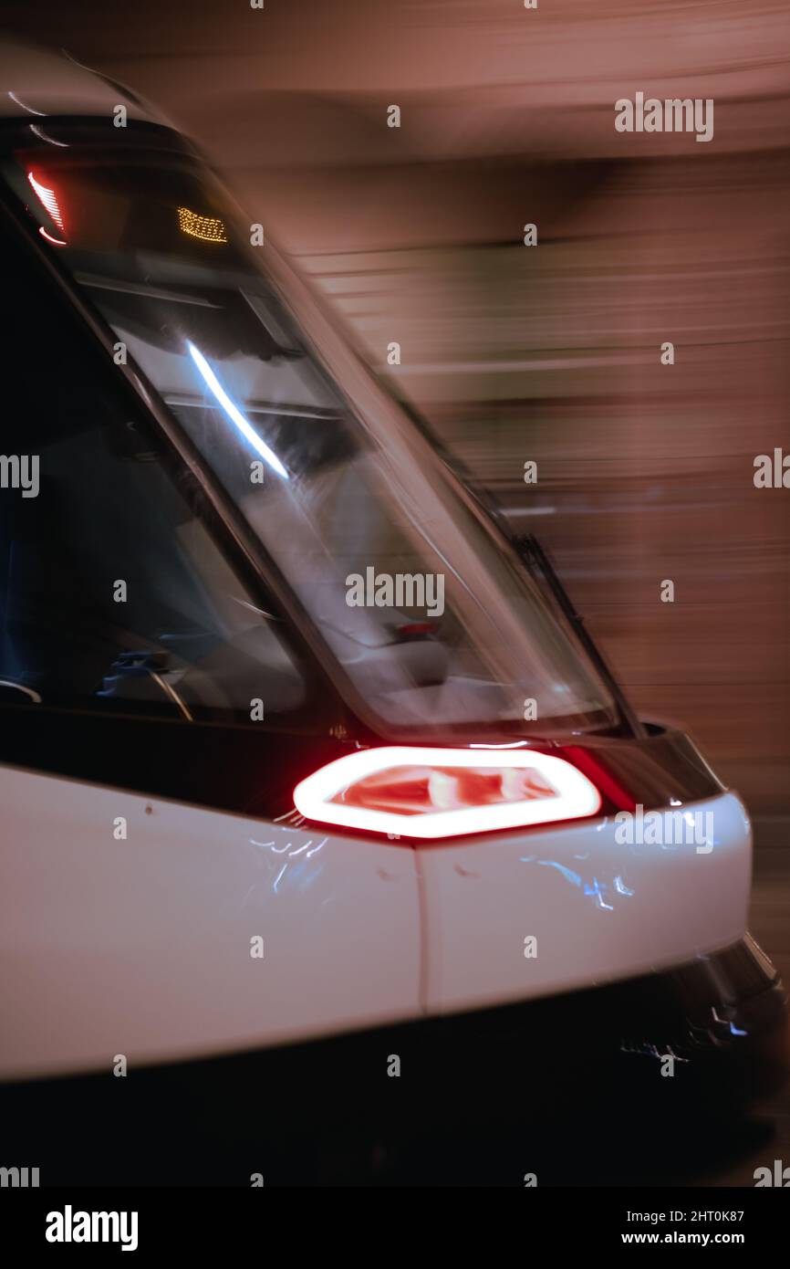 Closeup shot of a high-speed train front part in motion, Strasbourg at night, France Stock Photo