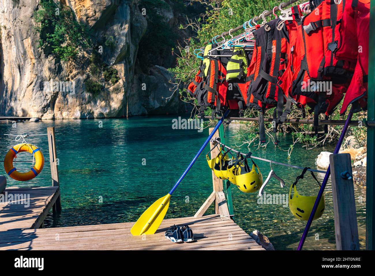 Pier for rafting with folded equipment - life jackets, helmets, oars ...