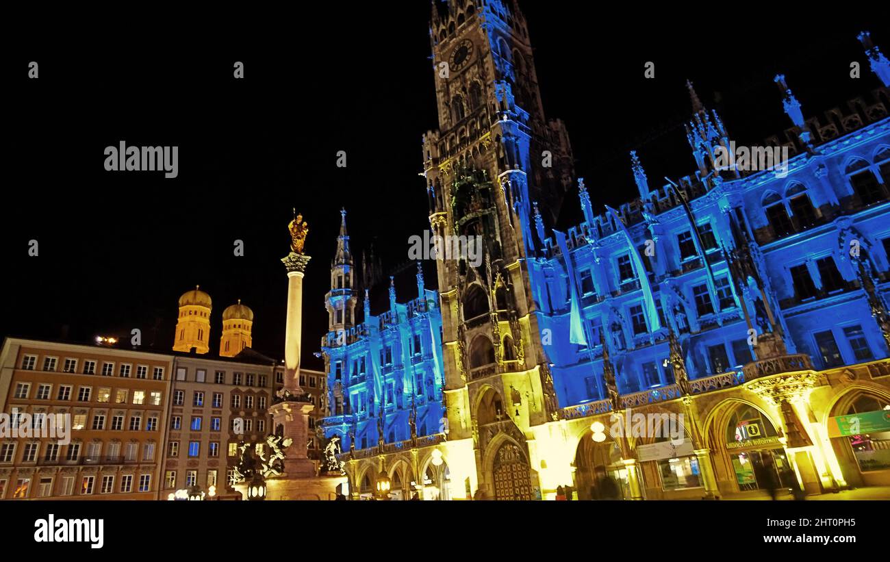 Munich Germany - February 25 2022  - The gothic Town Hall in Marienplatz illuminated with the blue-yellow colors of the Ukraine flag Stock Photo