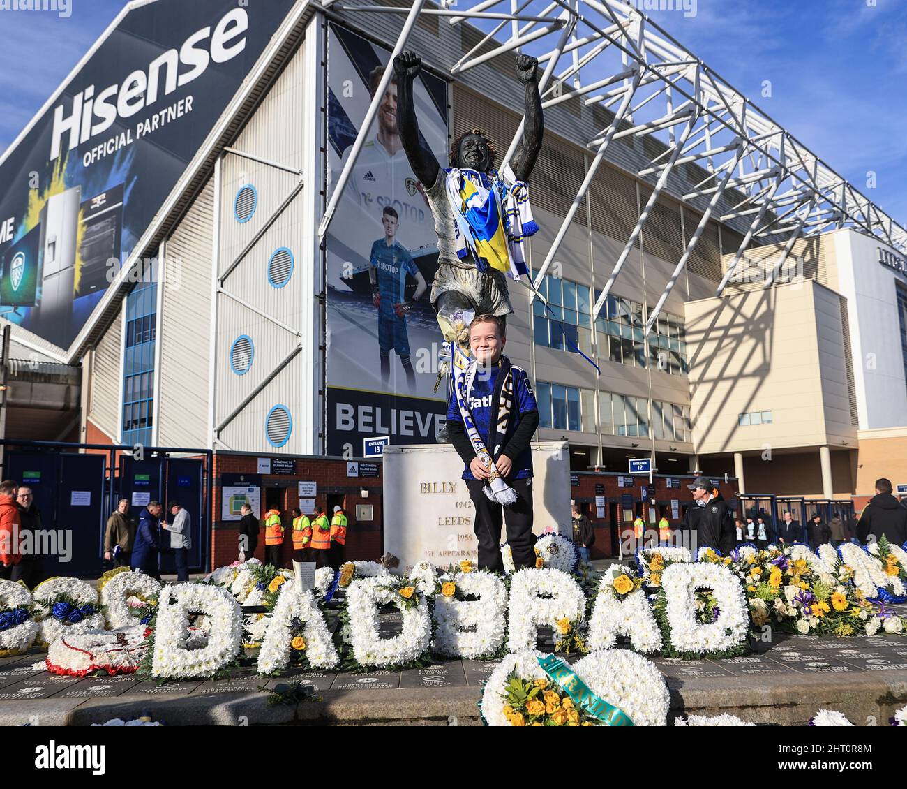 A young fan hashis photo taken at the Billy Bremner statue outside