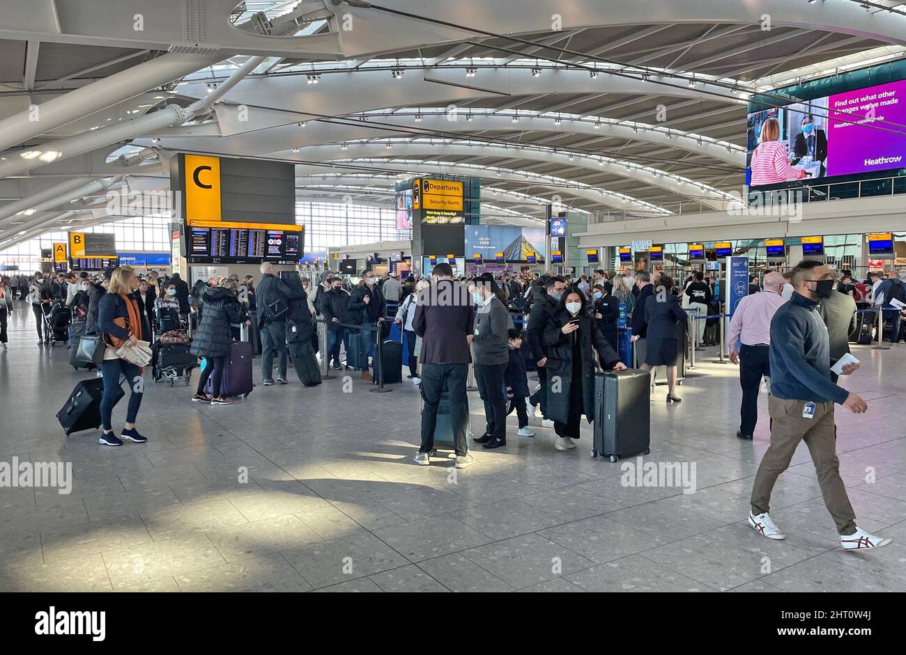 Passengers at Heathrow Airport T5, London, as British Airways has cancelled all short-haul flights from the airport until midday and further disruption is expected throughout Saturday due to ongoing technical issues. Picture date: Saturday February 26, 2022. Stock Photo