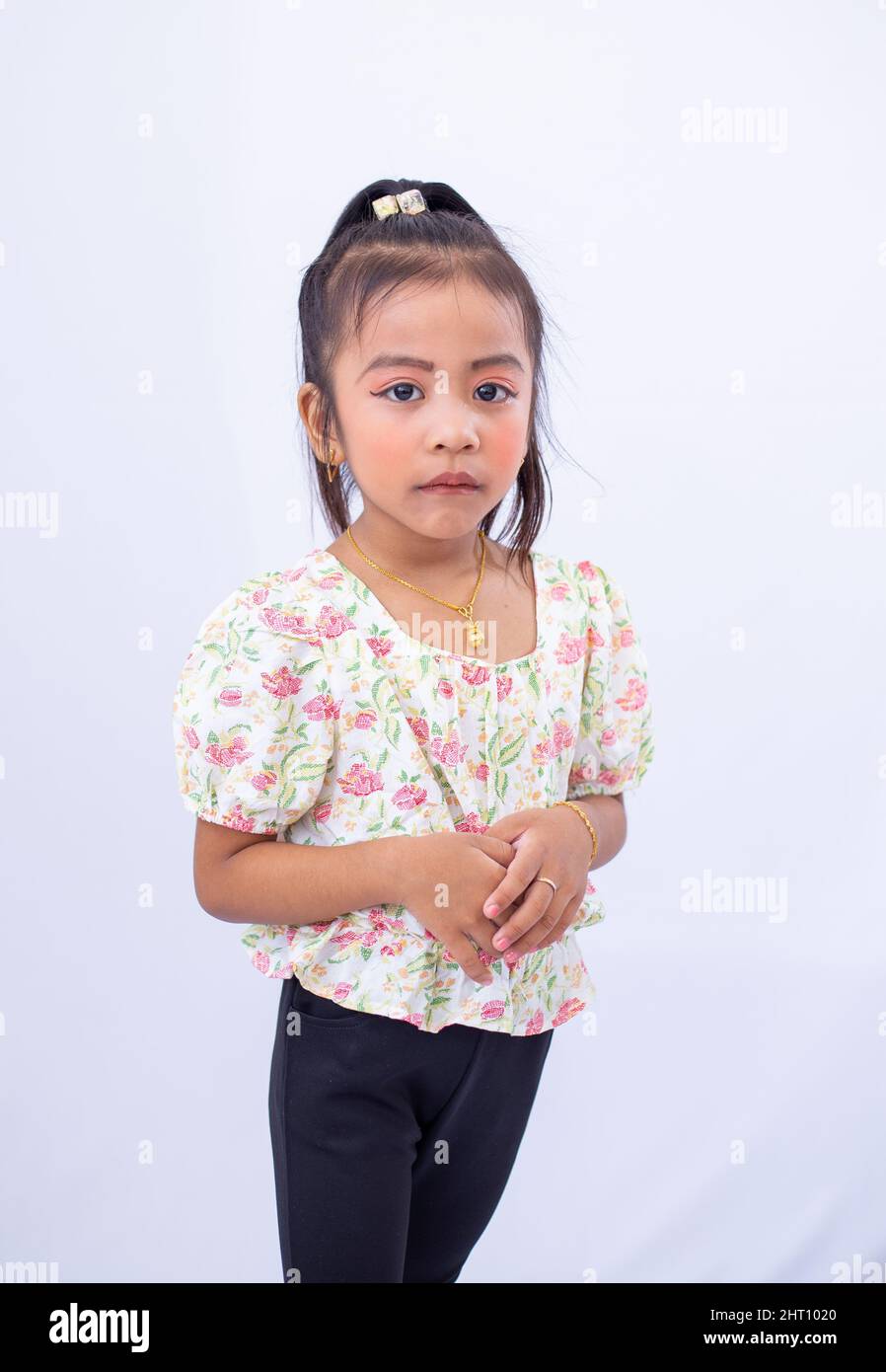 Closeup of a little girl posing on white background Stock Photo - Alamy