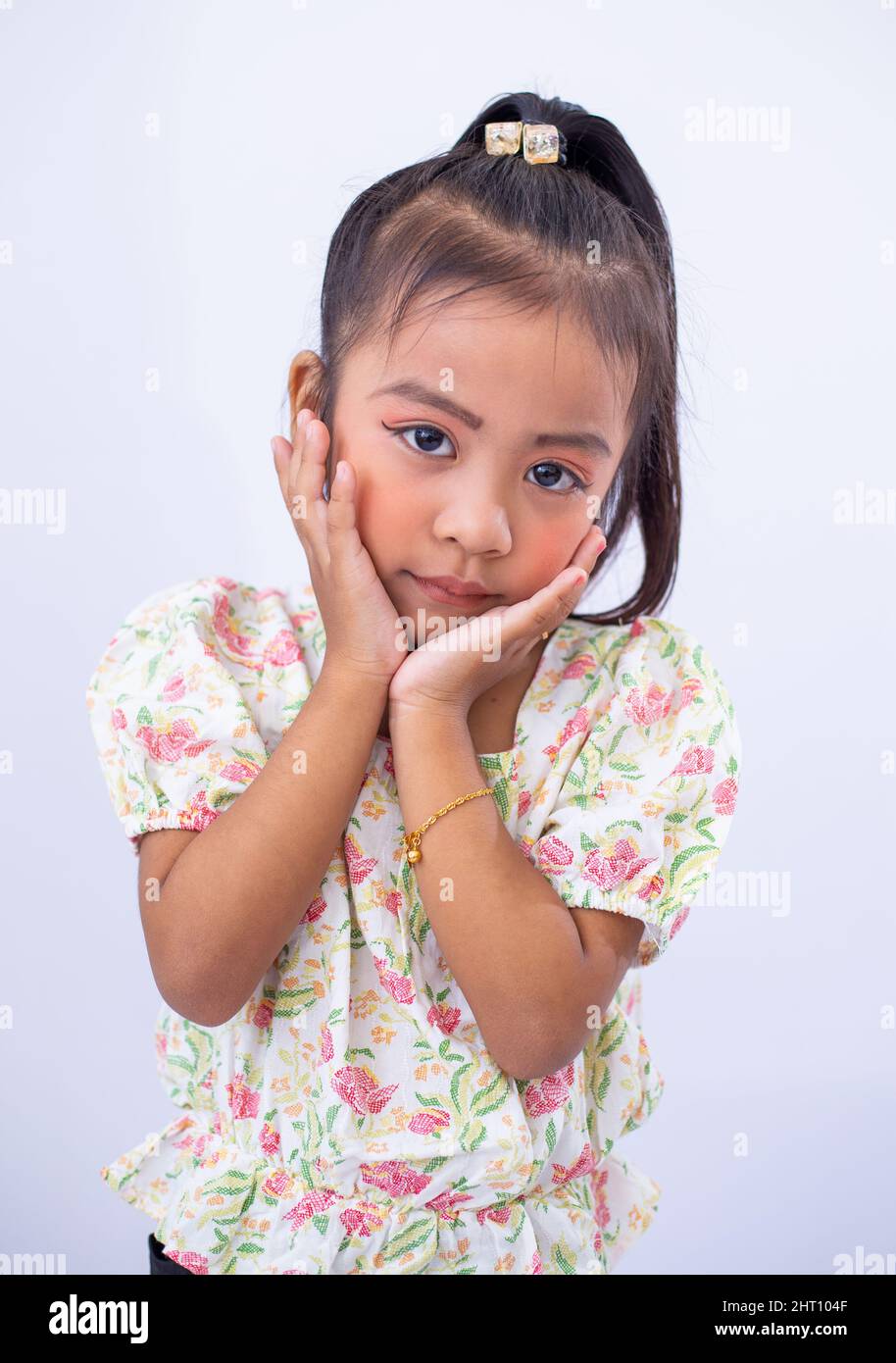 Closeup of a little girl posing on white background Stock Photo - Alamy