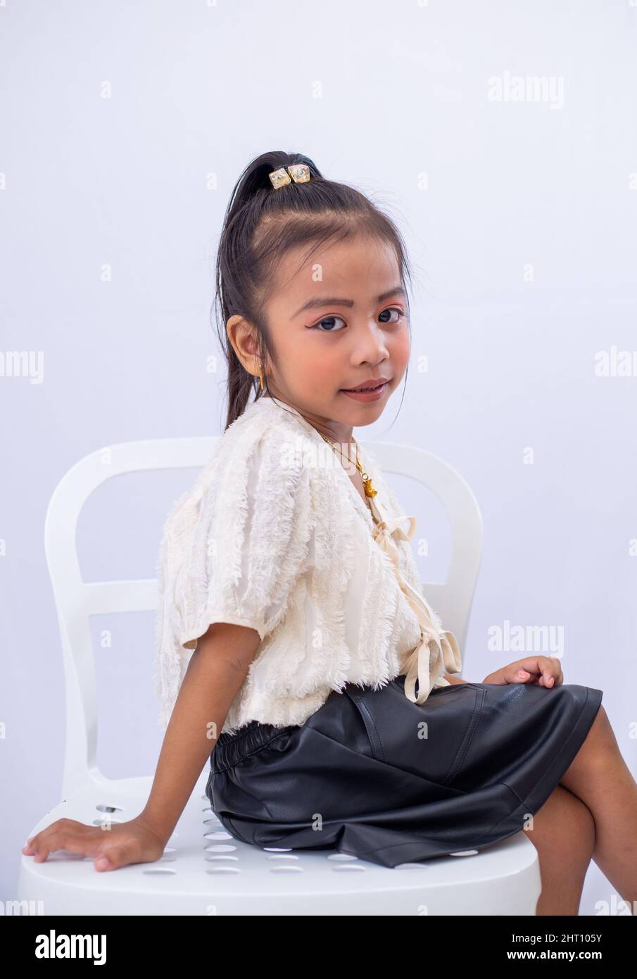 Closeup of a little girl posing on white background Stock Photo - Alamy