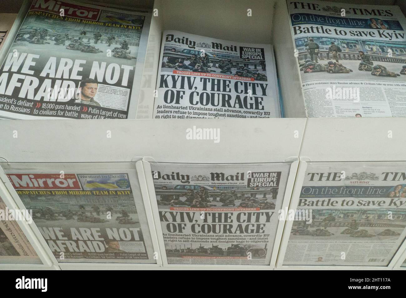 London, UK, 26 February 2022: In a supermarket newspaper rack the front pages of the British national press all display support and sympathy for Ukraine and the Ukrainian people after Vladimir Putin illegally invaded the country on 24 February 2022. The Ukrainian army are trying to defend Kyiv and the Russian have been bombing apartment blocks. Anna Watson/Alamy Live News Stock Photo