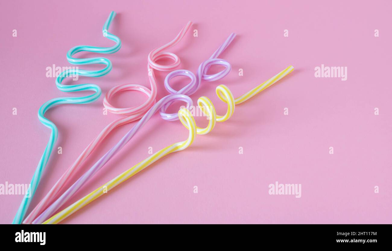 Cocktail straws Day. Drinking straws on a pink background. Summer cocktail party, a fun and happy holiday concept. Stock Photo