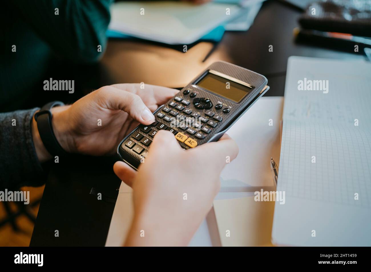 Hands of young male student using calculator at university Stock Photo