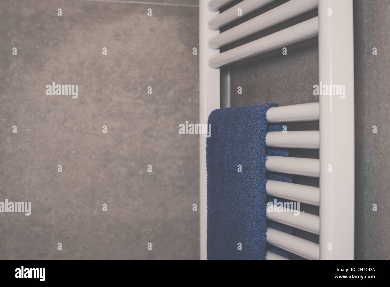 Towels heat up on a modern design radiator in the bathroom. Closeup ...