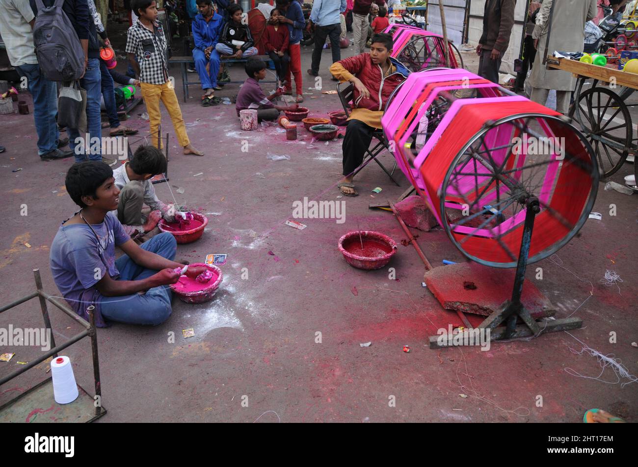 Children preparing Manja (colorful kite thread) for kite flying in the