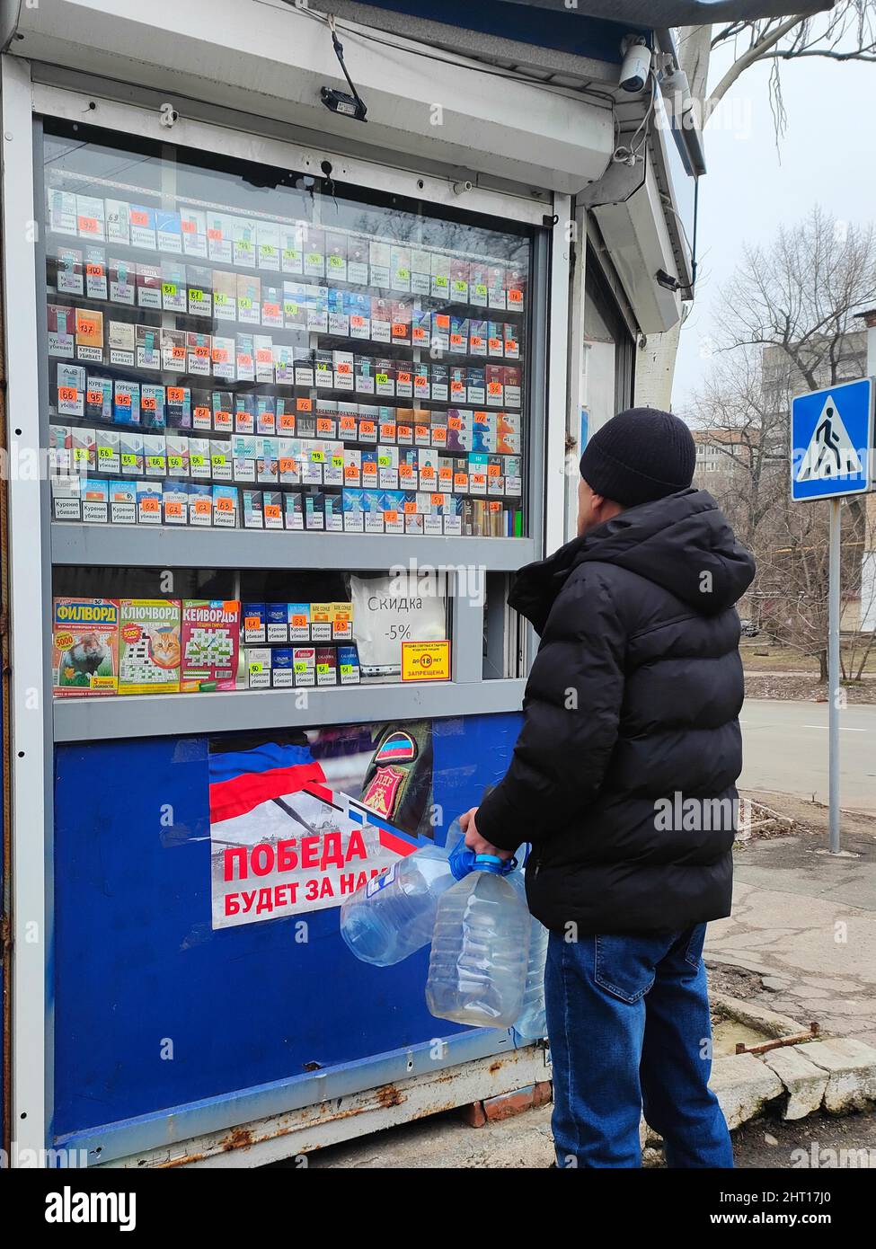 Donetsk. 26th Feb, 2022. A man stands in front of a shop in Donetsk, Feb. 26, 2022. Credit: Xinhua/Alamy Live News Stock Photo