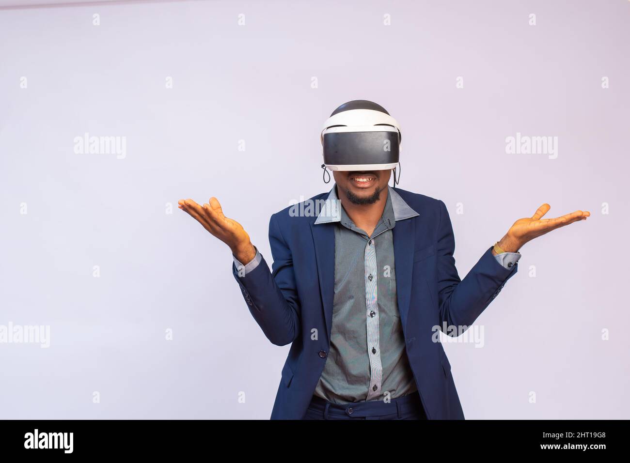 African businessman wearing virtual goggles with hands up isolated on ...
