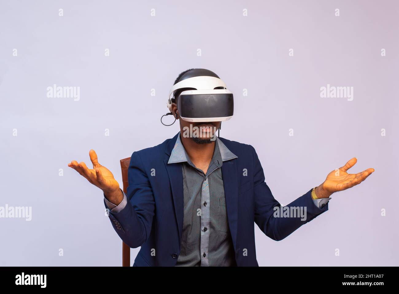 An African businessman wearing a virtual reality glasses isolated on a ...