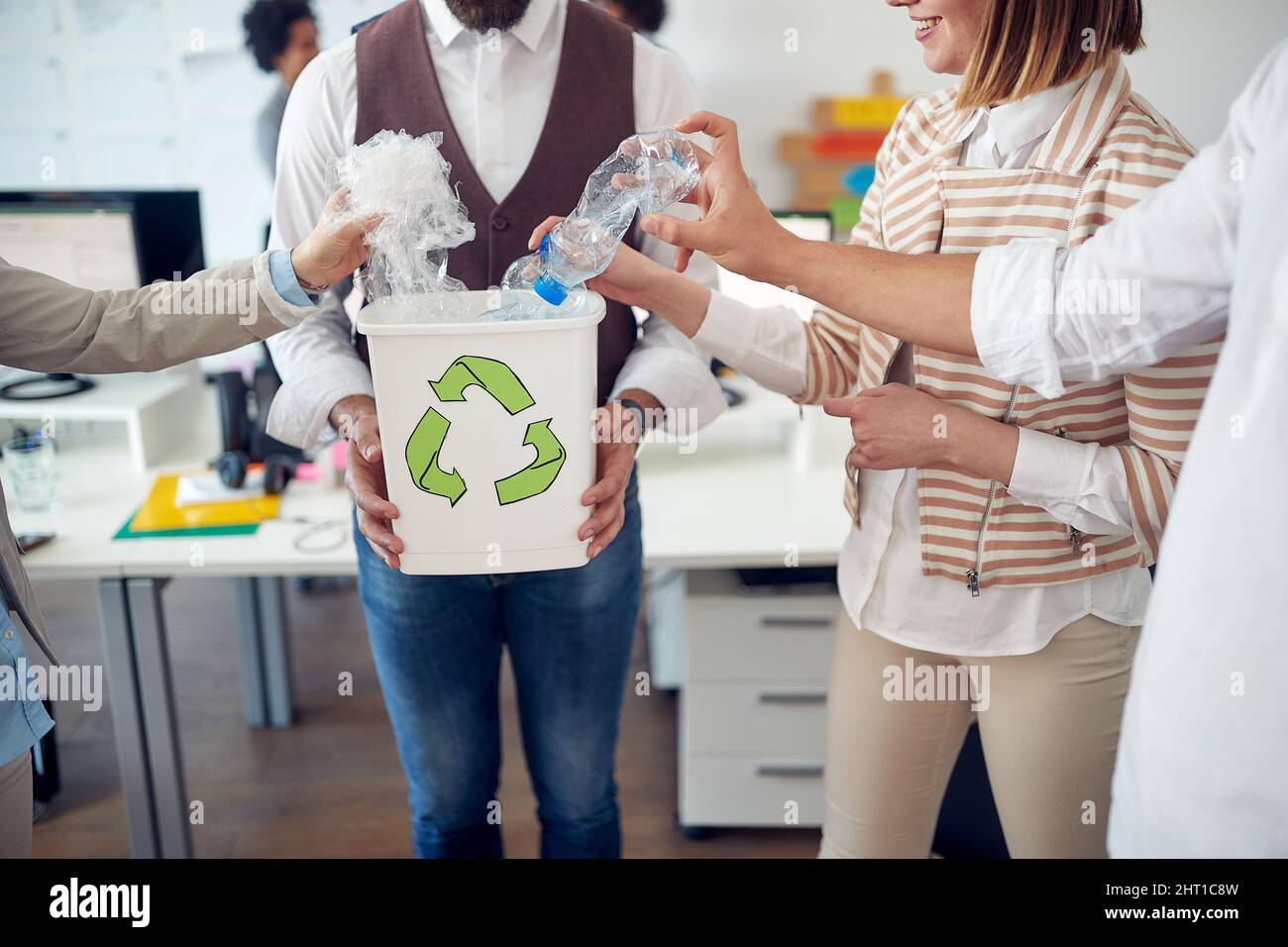 Closeup of a group of employees recycling the trash by collecting it
