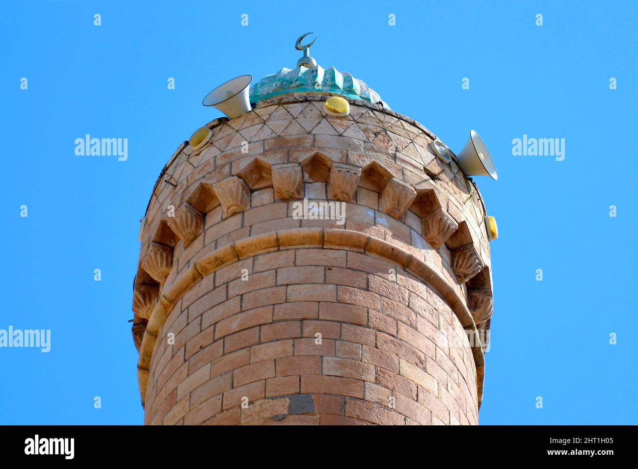 The top, the roof of the minaret with the symbol of the crescent moon and the speakers through which the muezzin singer calls for prayer, Muslim archi Stock Photo