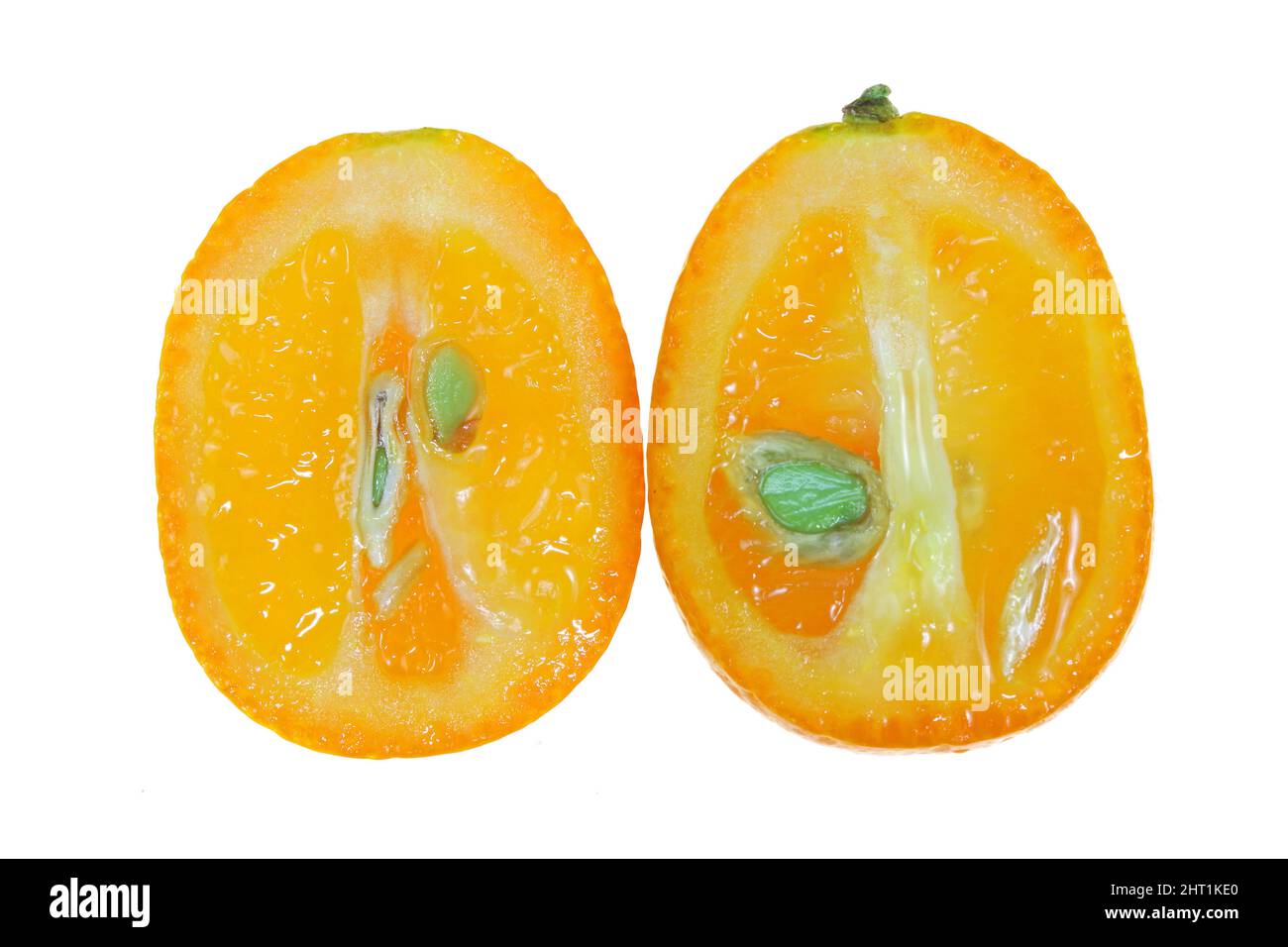 Sliced juicy kumquat isolated on white, macro close up. Stock Photo