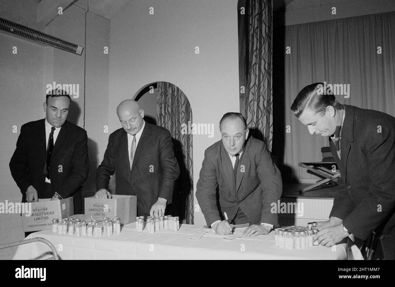 Blood samples being checked by detectives at Beenham Village Hall in the hunt for the killer of Yolande Waddington. They are left to right: Sergeant Boff, Superindent Wallis Virgo of the Murder Squad, Detective Superintendant Lawson of Berkshire CID and an unidentified detective. 23rd November 1966. Stock Photo