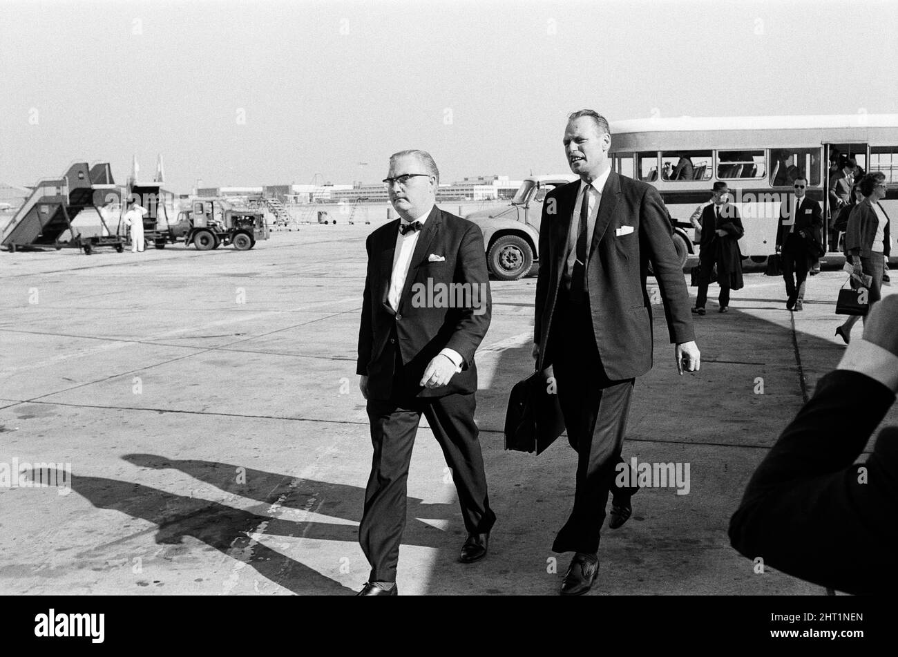 Detective Chief inspector John Hensley (wearing glasses) and Detective Inspector Jack Slipper leave London airport for Glasgow to bring John Duddy back to London. John Duddy was wanted for questioning in connection with the shooting of three London policemen. He later went on to be convicted of murder and possession of firearms and sentenced to life imprisonment. 18th August 1966. Stock Photo