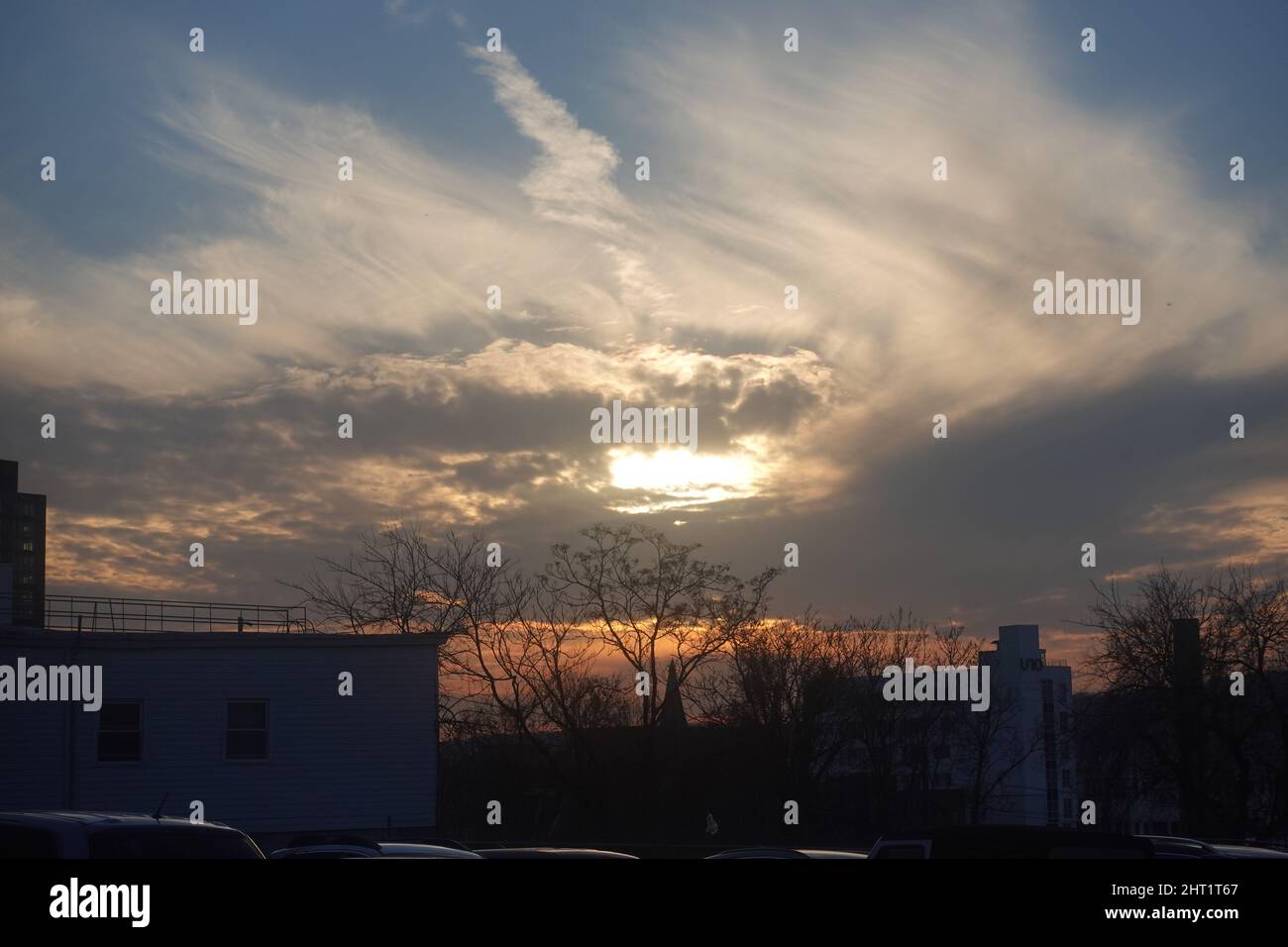 Beautiful scene of the sunrise sky on building and trees in West Point